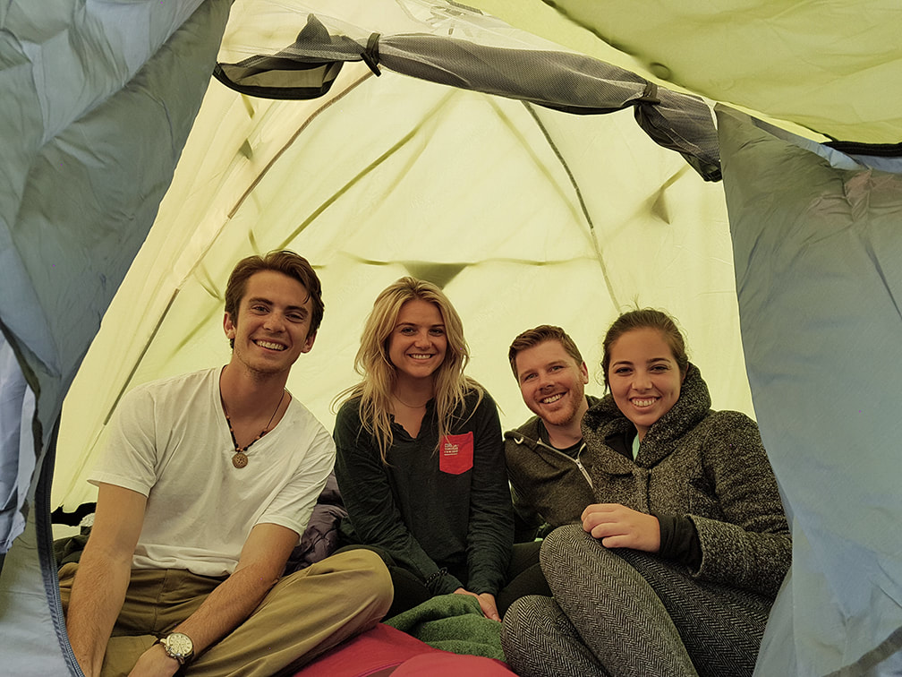 Four people in a tent